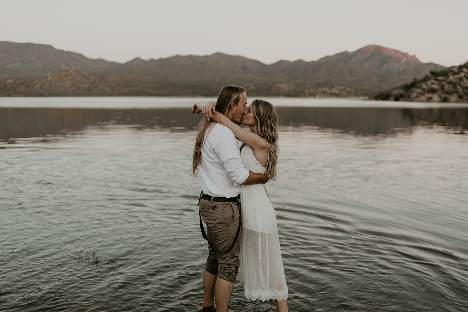 stunning couple play in Bartlett Lake during their Arizona engagement photoshoot