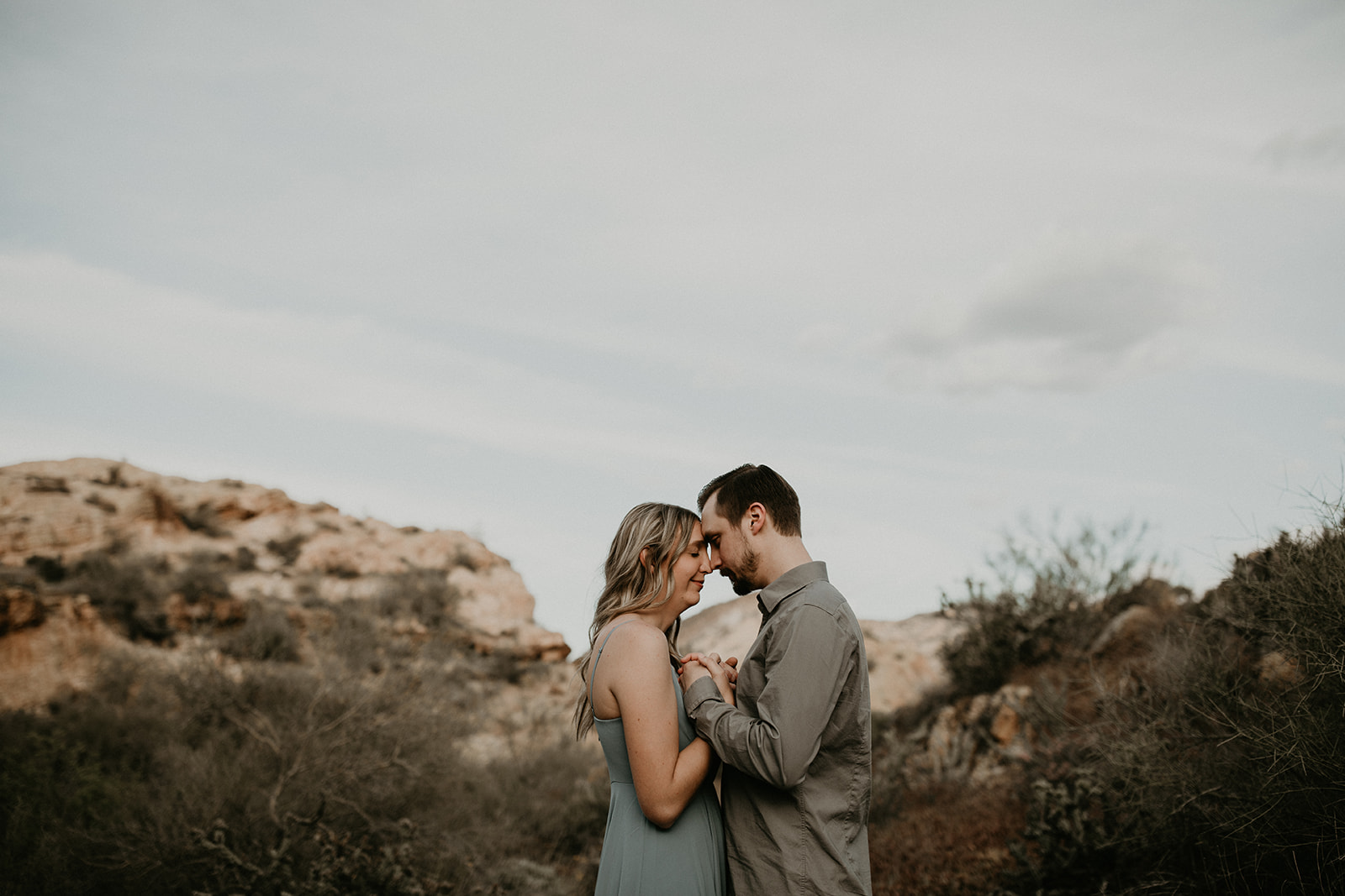 stunning couple pose together in Arizona during their dreamy Canyon Lake engagement photoshoot