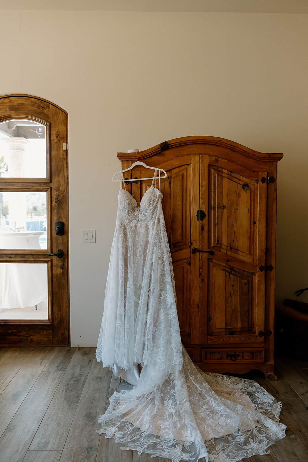 wedding dress hangs before the bride prepares