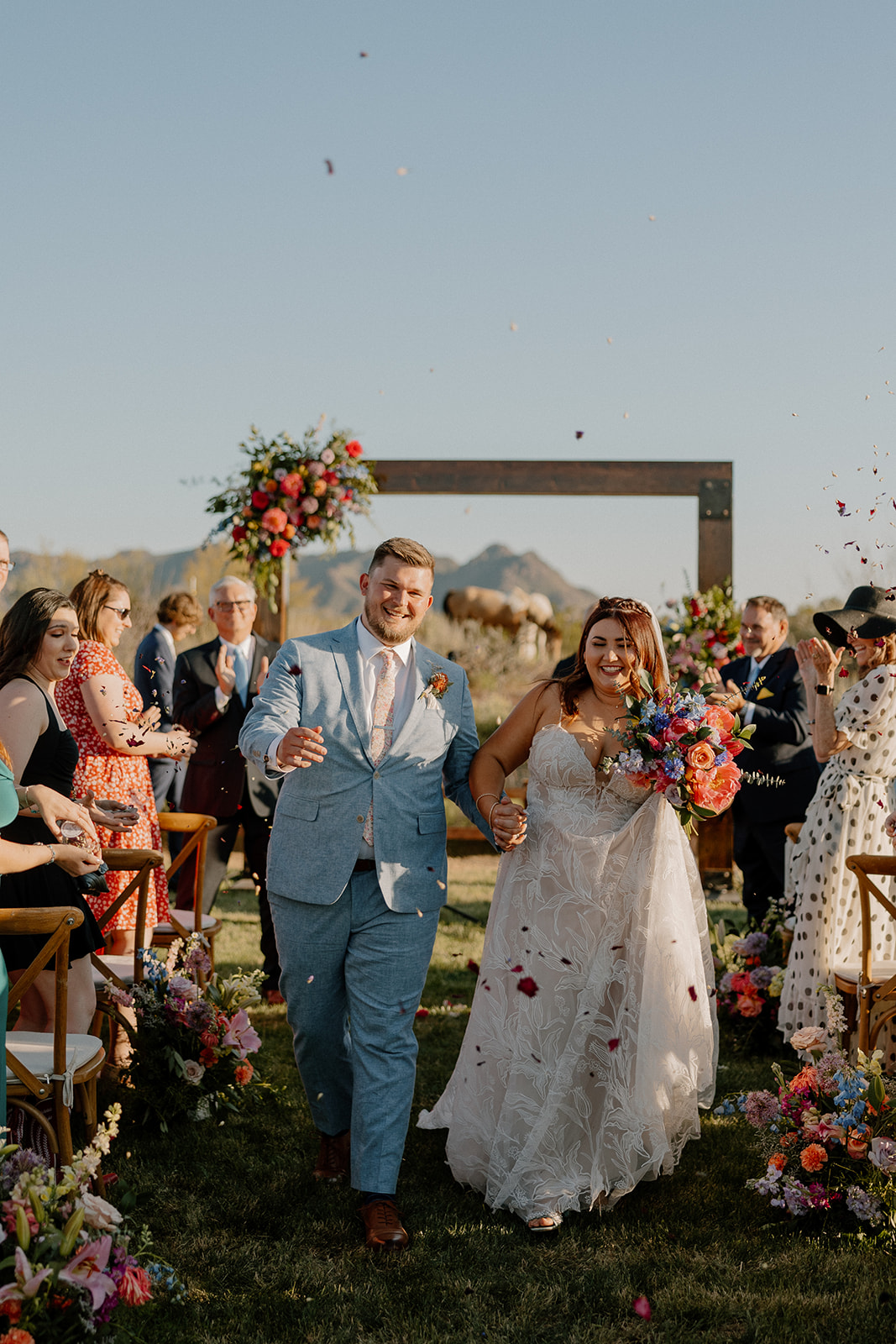 bride and groom walk out of their dreamy backyard Arizona wedding ceremony