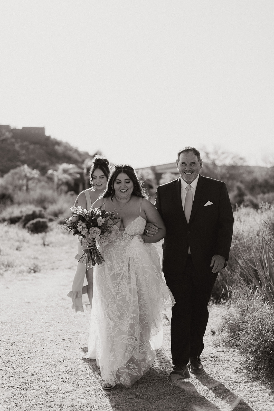 bride walks down the aisle with her dad 