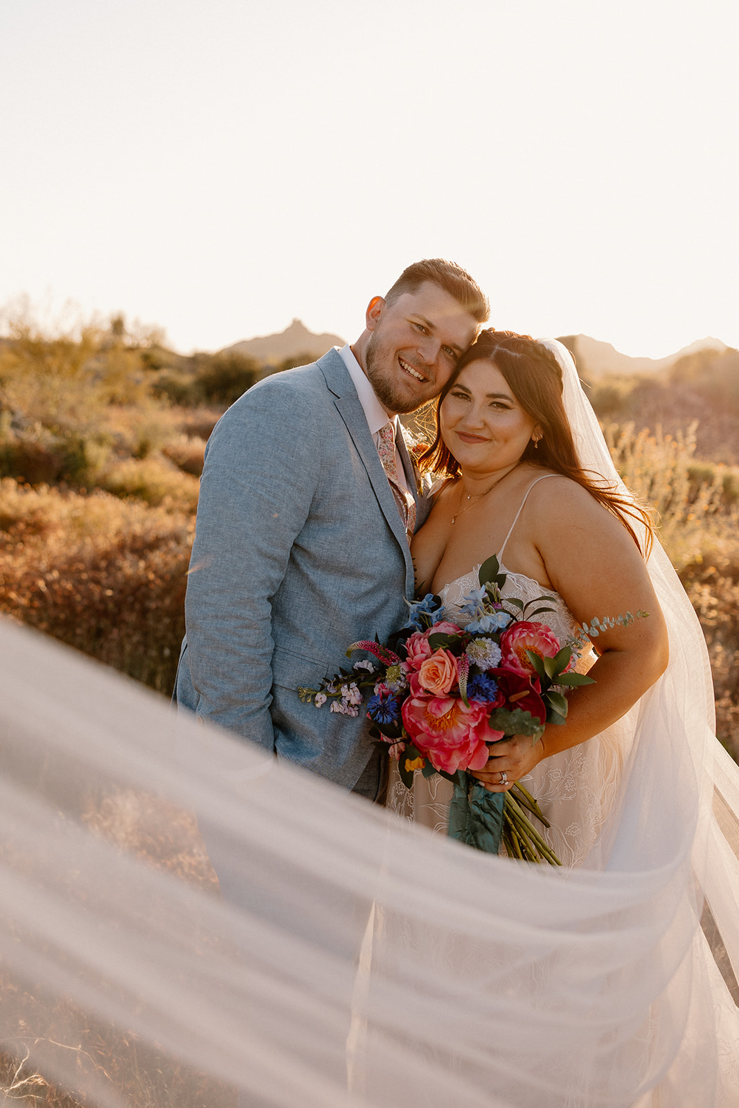 bride and groom pose in the beautiful Arizona desert