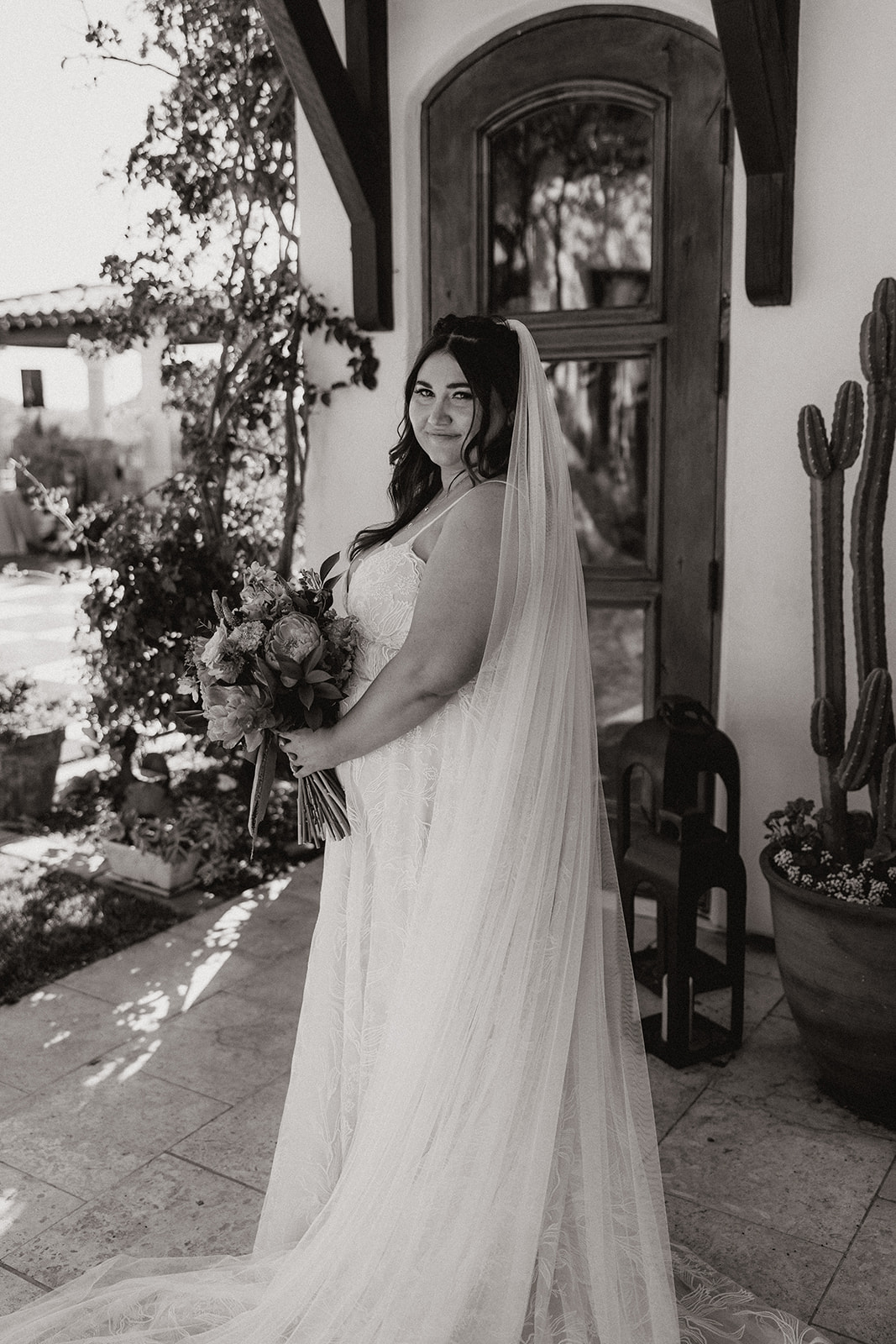 bride poses outside the dreamy Arizona wedding venue