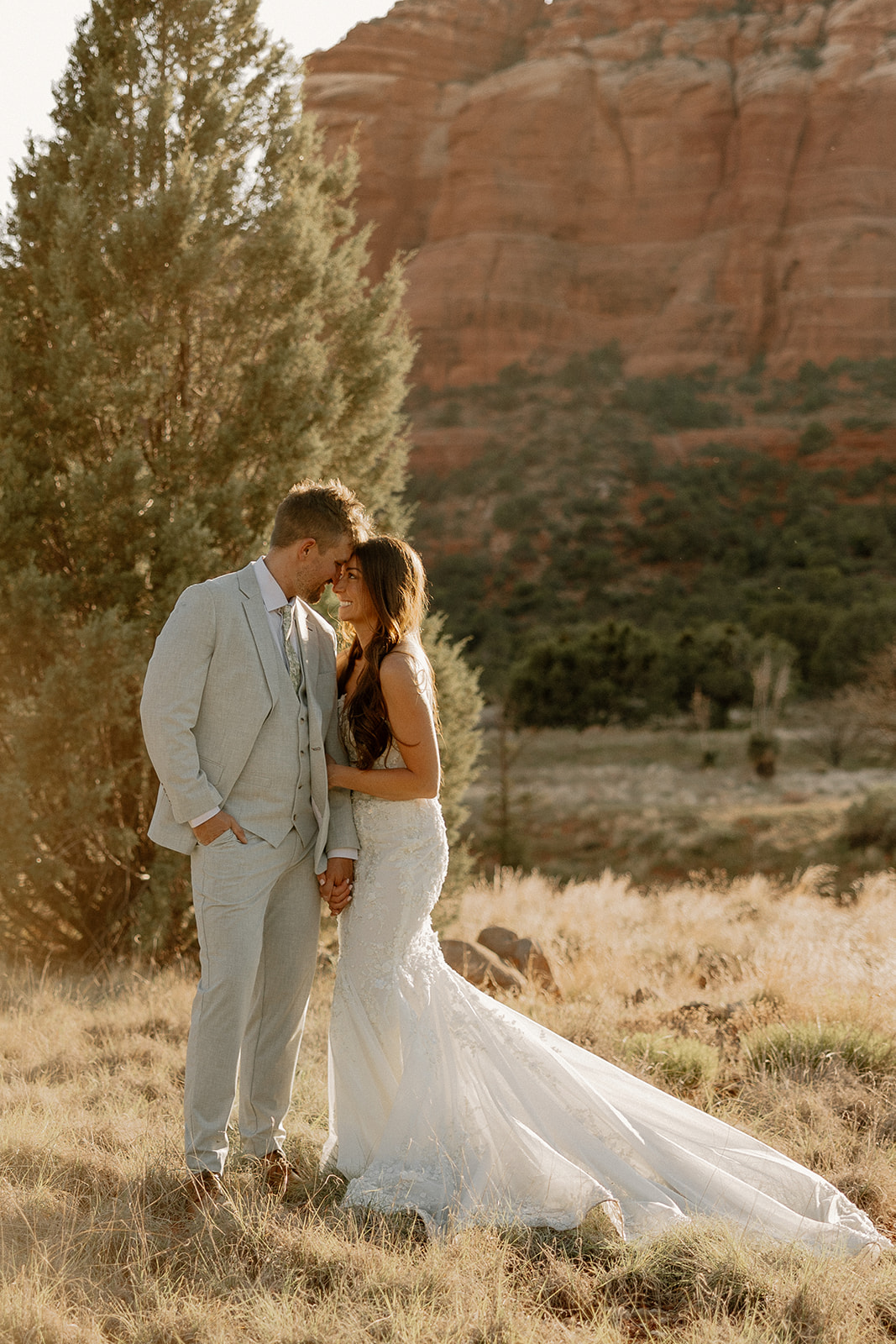 bride and groom pose together in the Arizona desert during their post wedding photoshoot