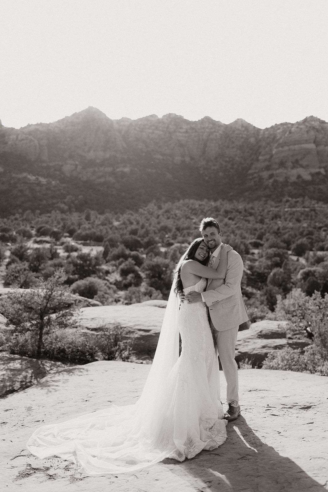 bride and groom pose together in the Arizona desert during their post wedding photoshoot