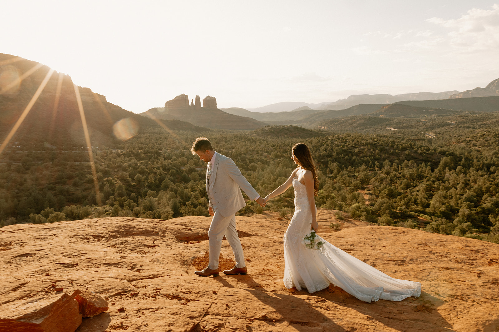 bride and groom pose together in the Arizona desert during their post wedding photoshoot