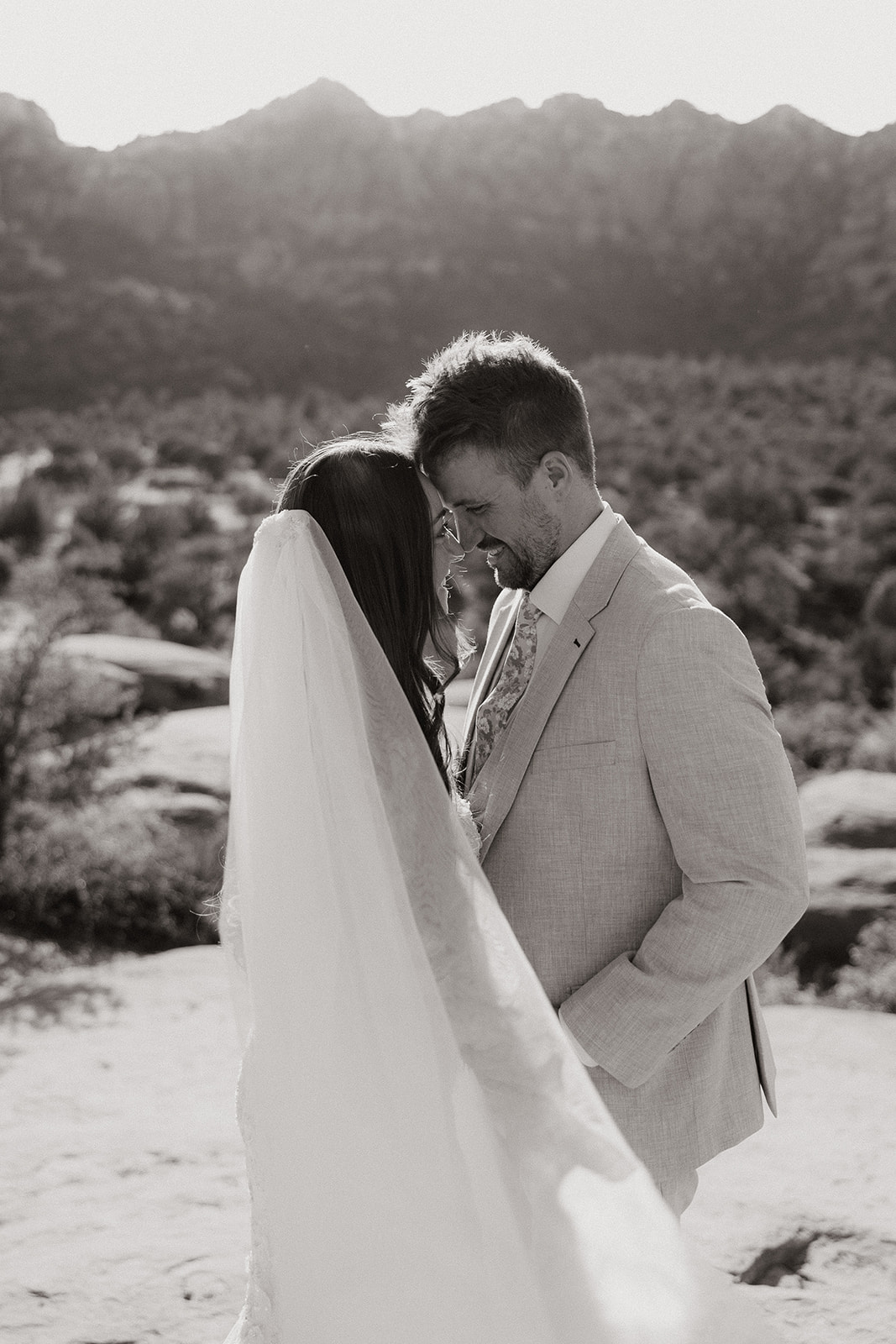 bride and groom pose together in the Arizona desert during their post wedding photoshoot