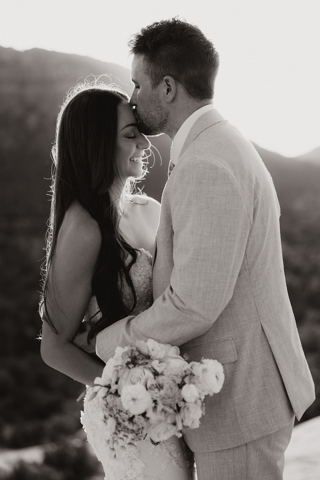 bride and groom pose together in the Arizona desert during their post wedding photoshoot