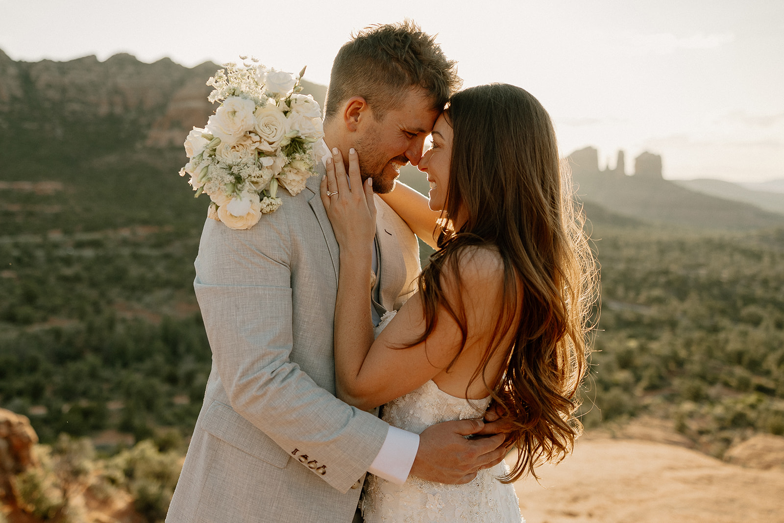 stunning bride and groom pose together with the Arizona desert in the background