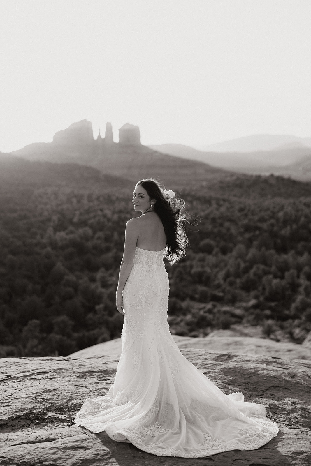 beautiful bride poses with the Arizona desert in the background