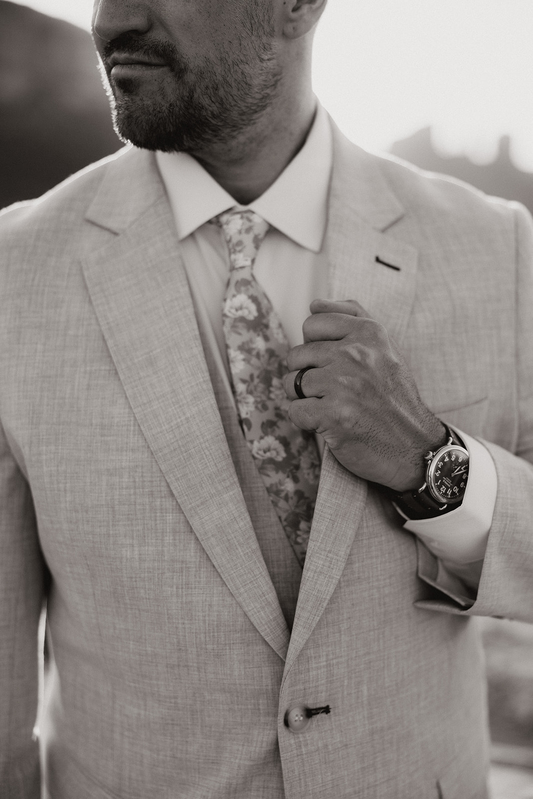 handsome groom poses with the Arizona desert in the background