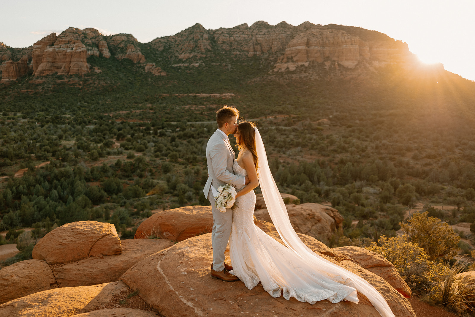 stunning bride and groom pose together with the Arizona desert in the background