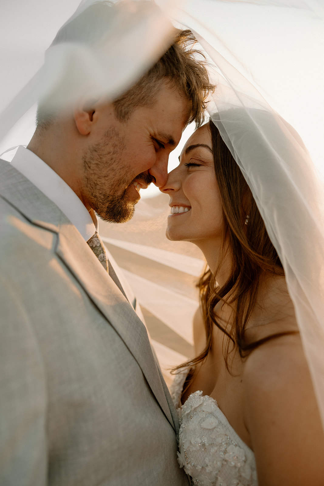 bride and groom pose together in the Arizona desert during their post wedding photoshoot