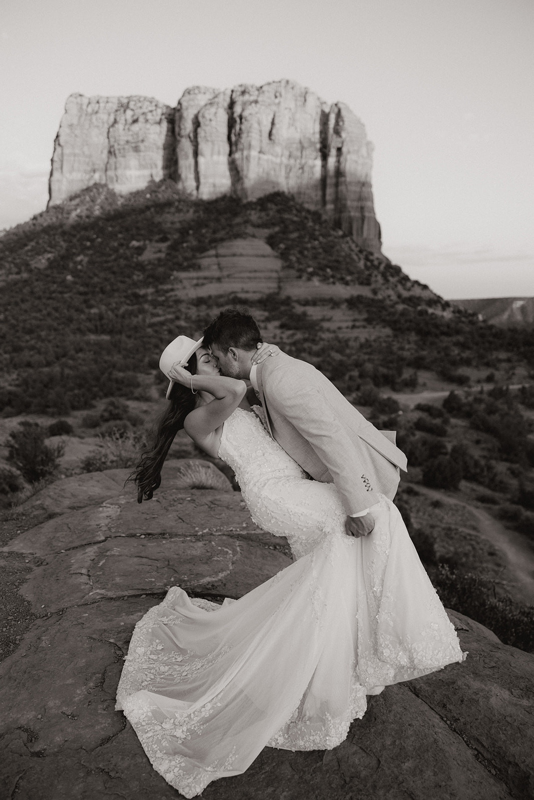 bride and groom pose together in the Arizona desert during their post wedding photoshoot