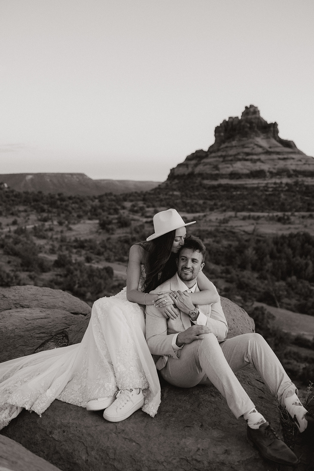 bride and groom pose together in the Arizona desert during their post wedding photoshoot