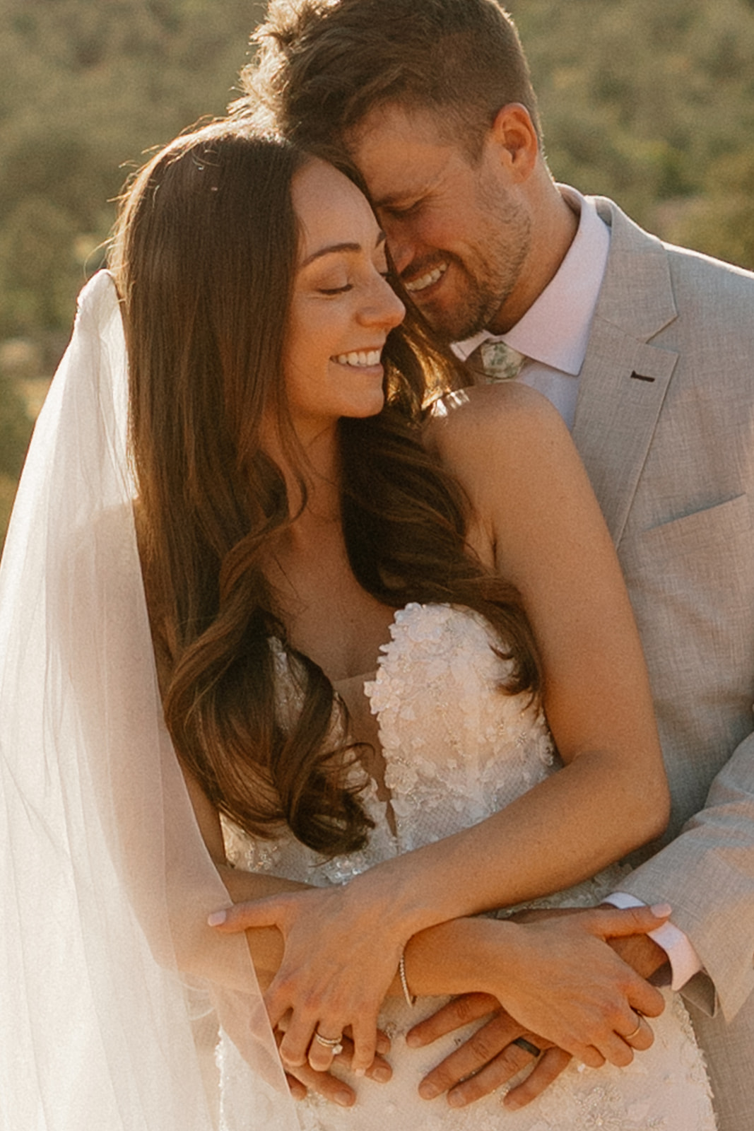 stunning bride and groom pose together with the Arizona desert in the background