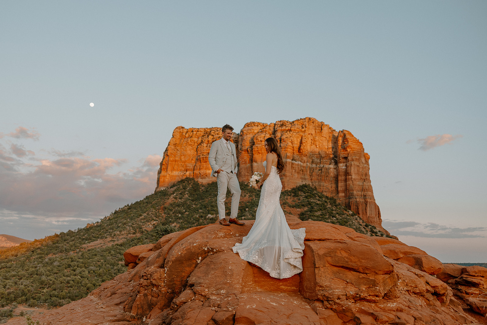 bride and groom pose together in the Arizona desert during their post wedding photoshoot