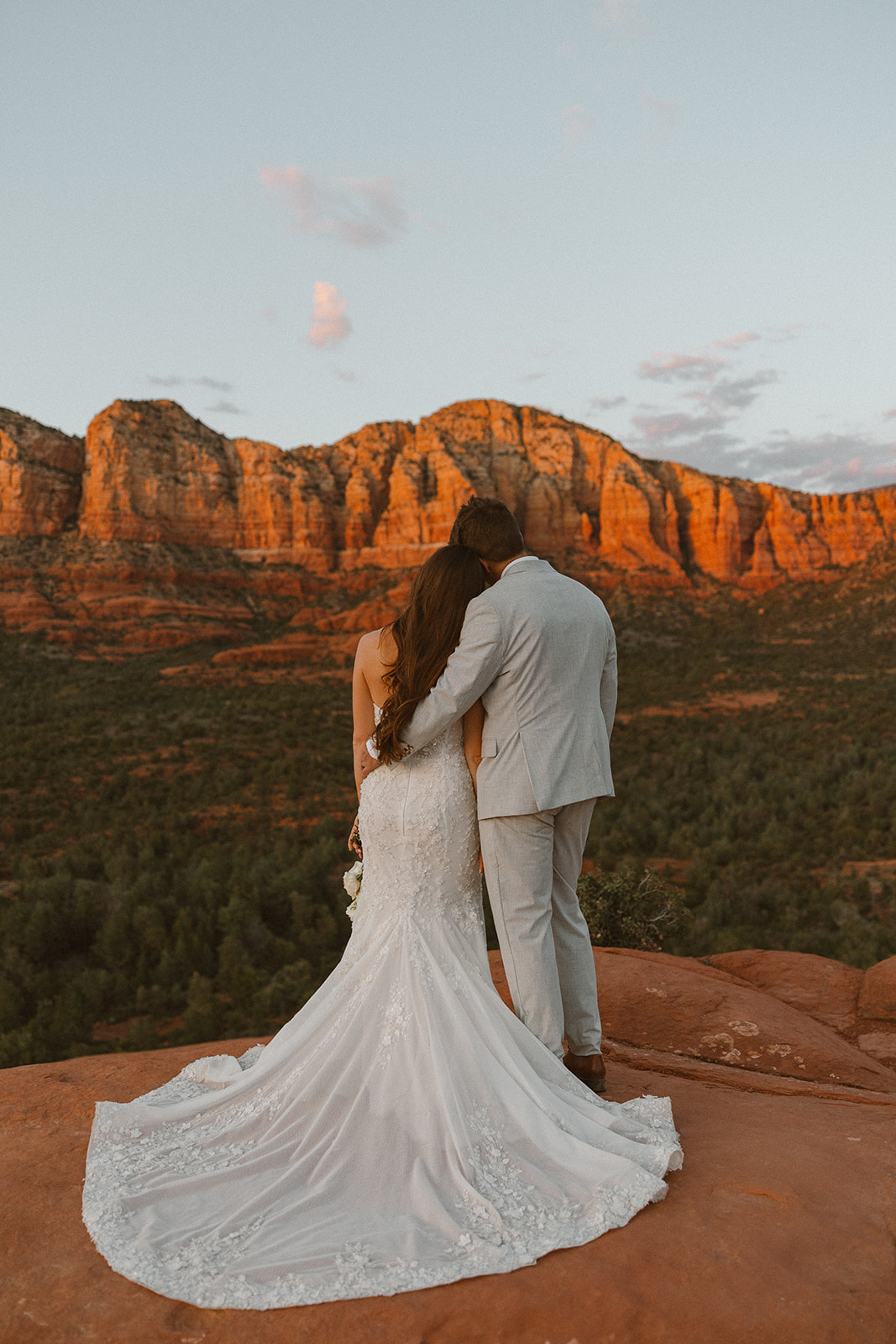 bride and groom pose together in the Arizona desert during their post wedding photoshoot