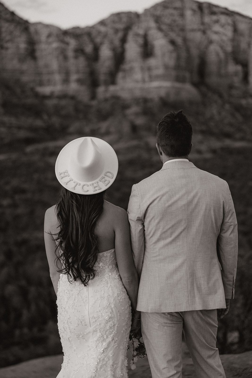 bride and groom pose together in the Arizona desert during their post wedding photoshoot