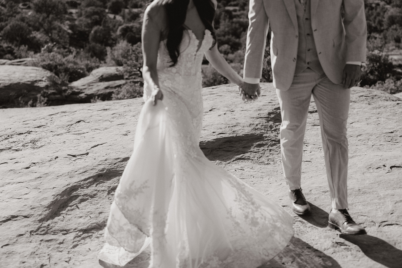 bride and groom pose together in the Arizona desert during their post wedding photoshoot