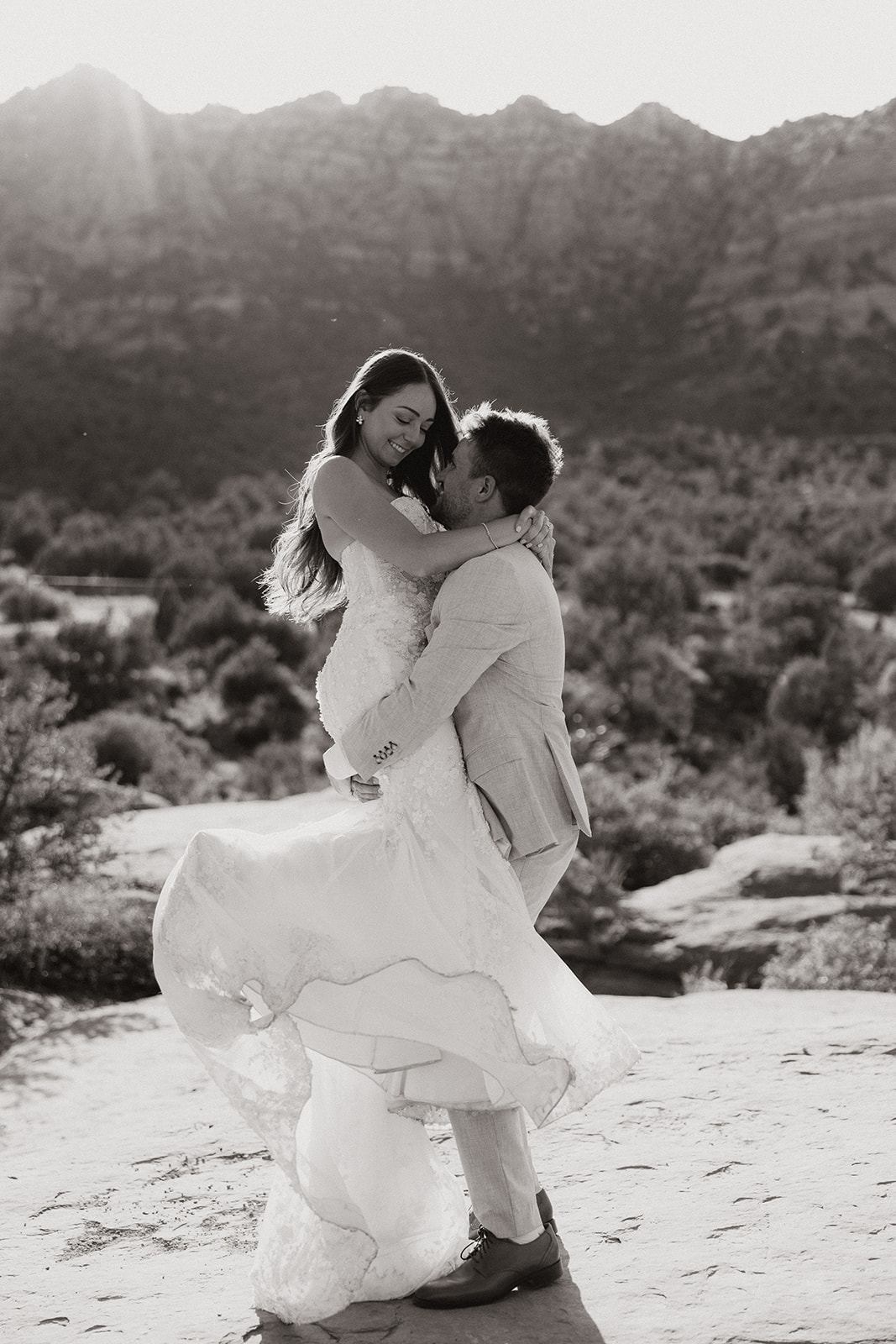 bride and groom pose together in the Arizona desert during their post wedding photoshoot