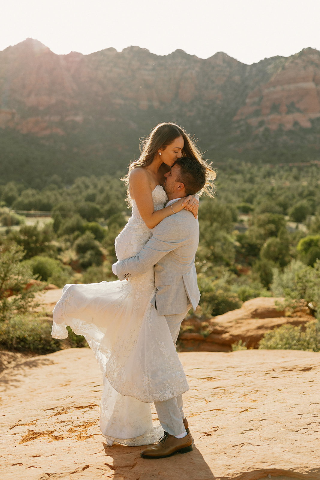 stunning bride and groom pose together with the Arizona desert in the background