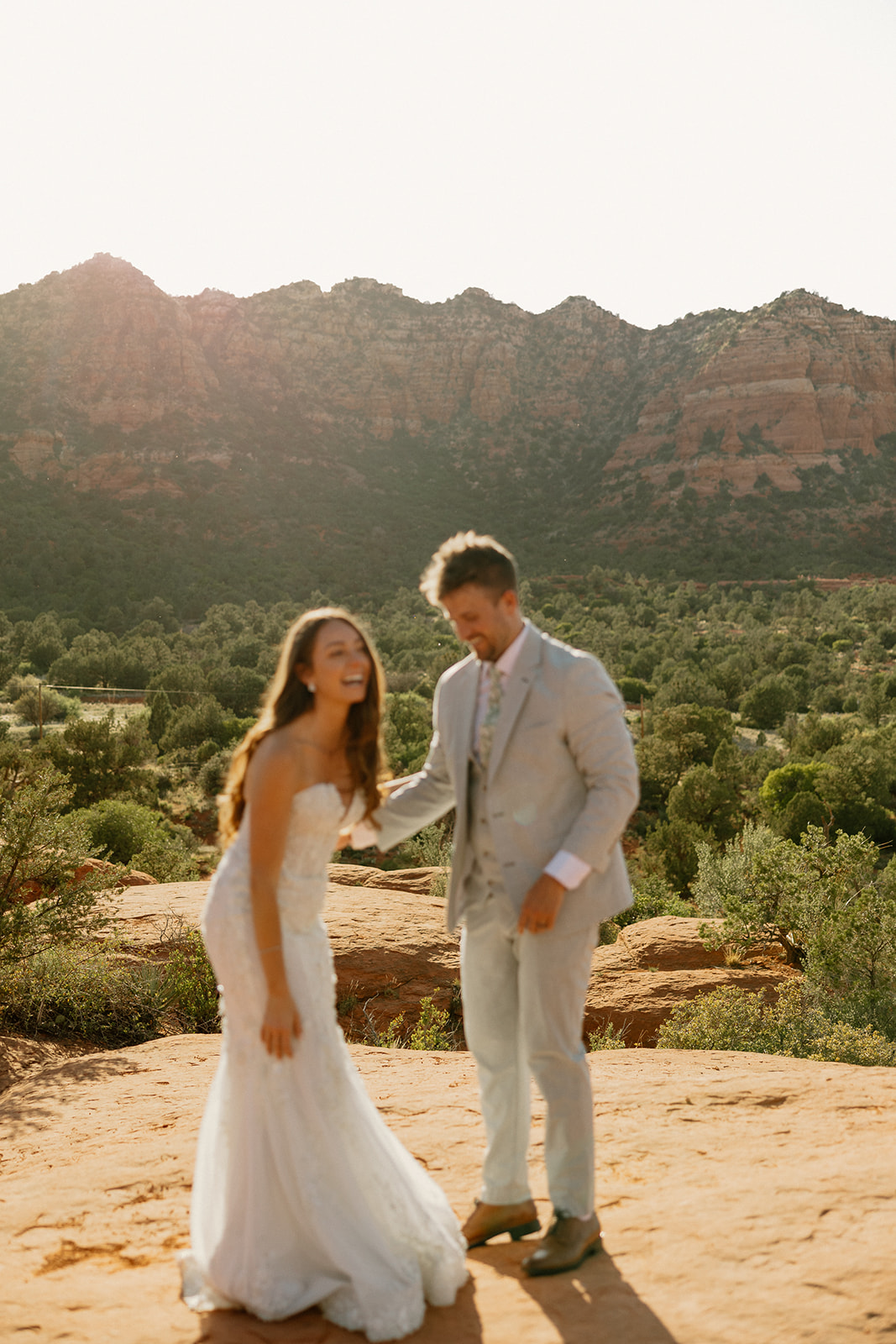 stunning bride and groom pose together with the Arizona desert in the background