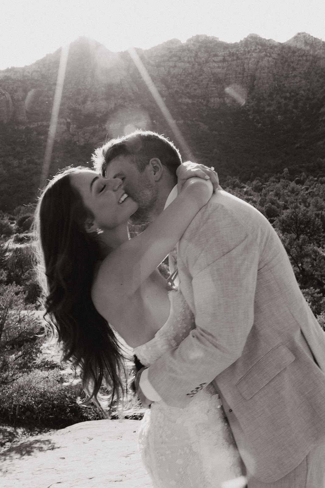 stunning bride and groom pose together with the Arizona desert in the background