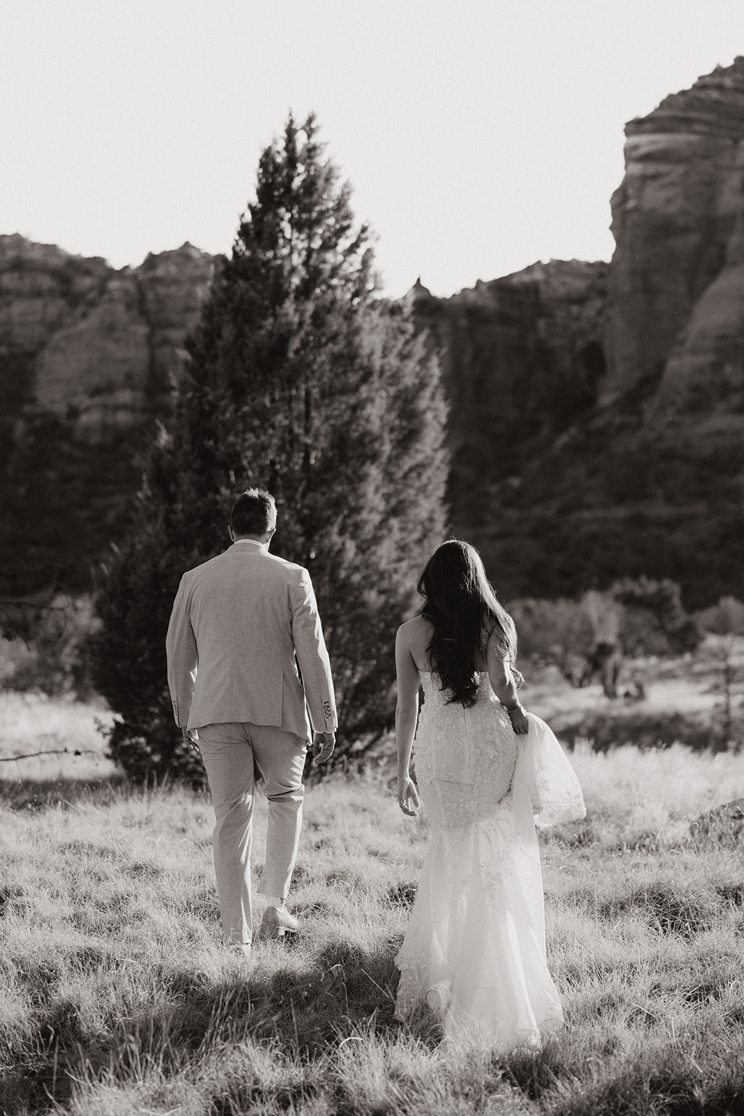 bride and groom pose together in the Arizona desert during their post wedding photoshoot