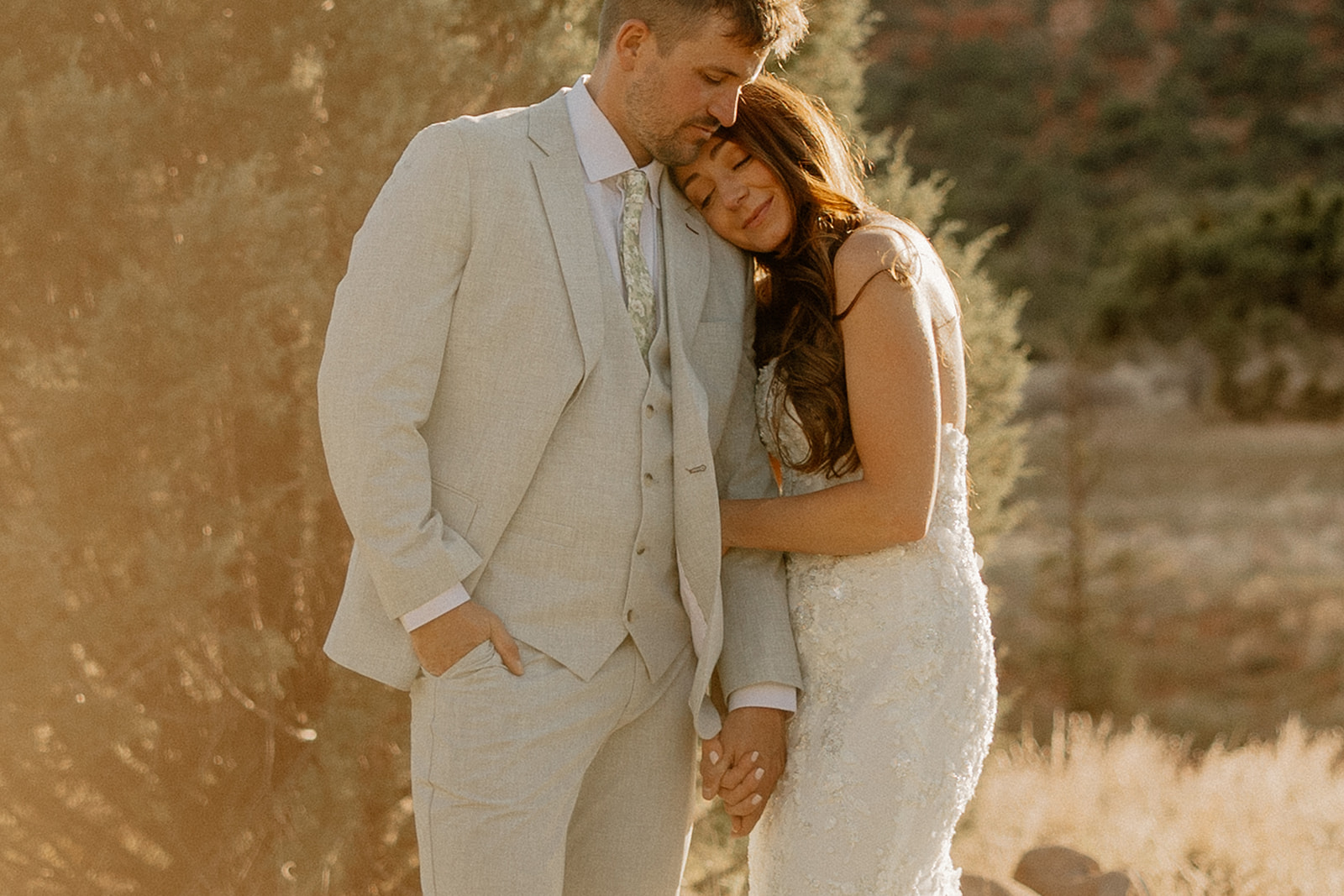 bride and groom pose together in the Arizona desert during their post wedding photoshoot