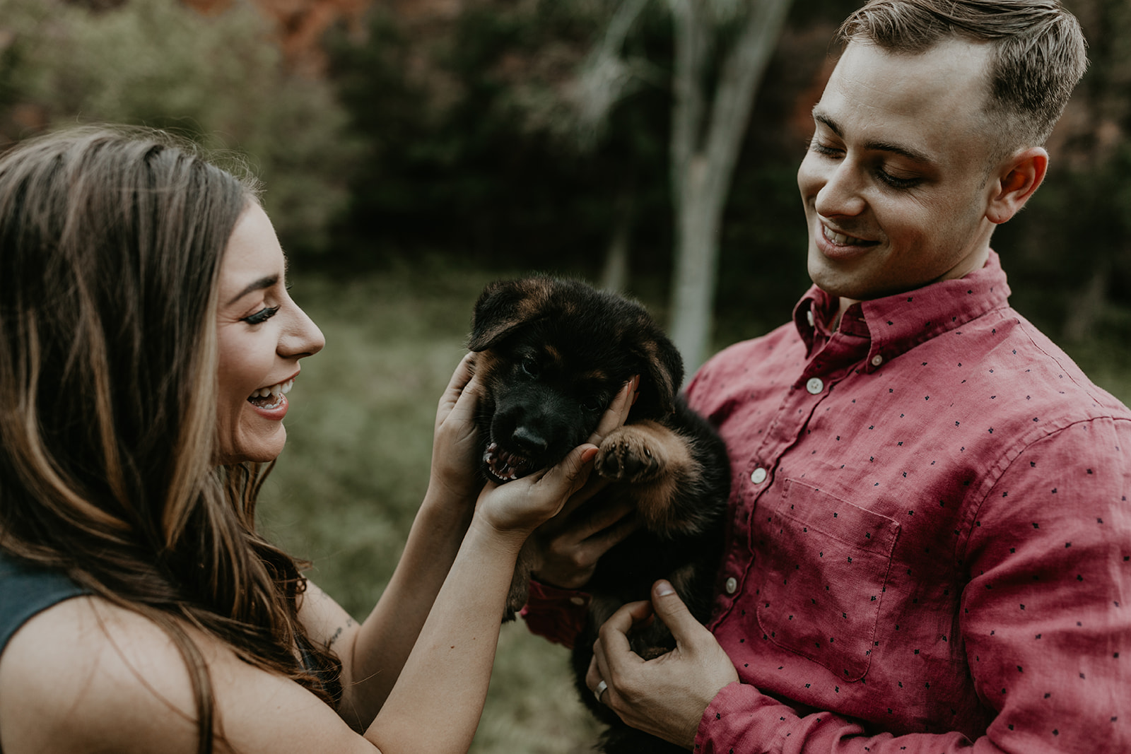 couple pose with their puppy during their Arizona engagement photoshoot