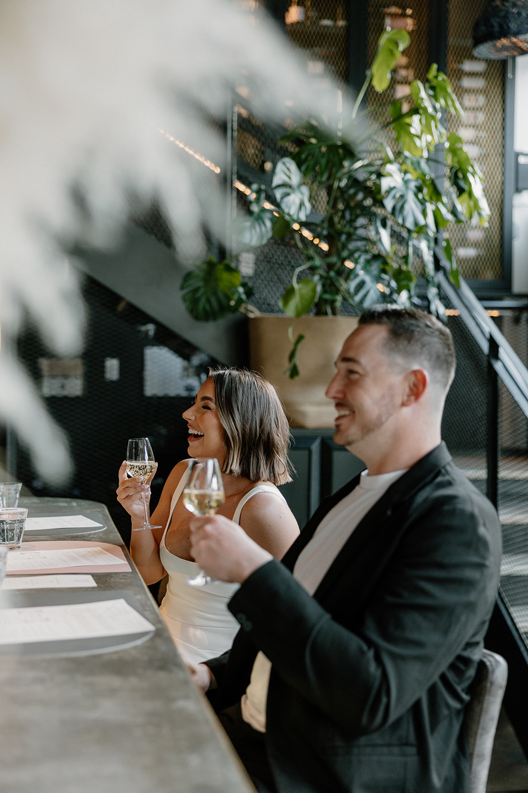 stunning couple share a candid laugh during their natural engagement photoshoot