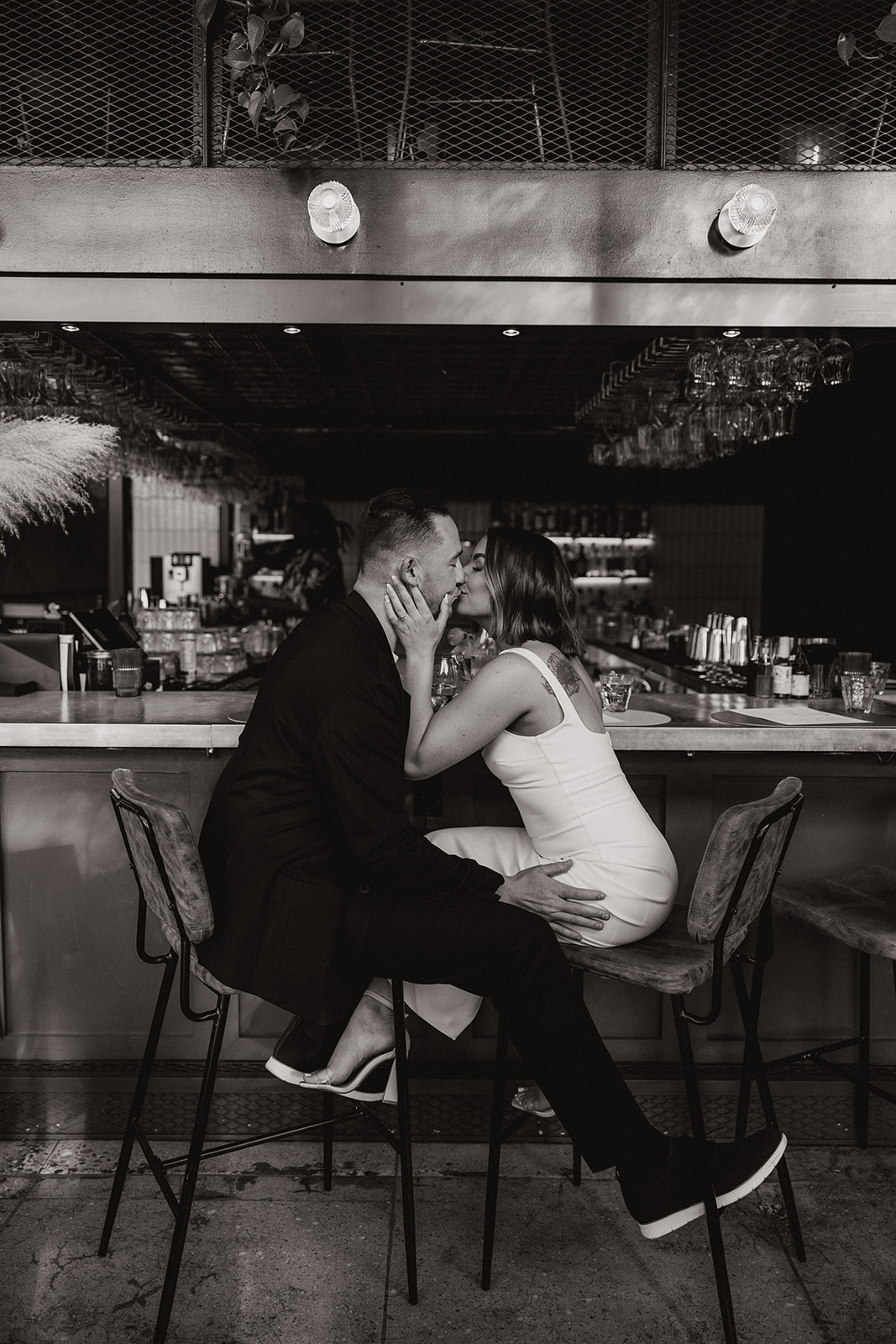 stunning couple share an intimate moment during their Arizona bar engagement photoshoot