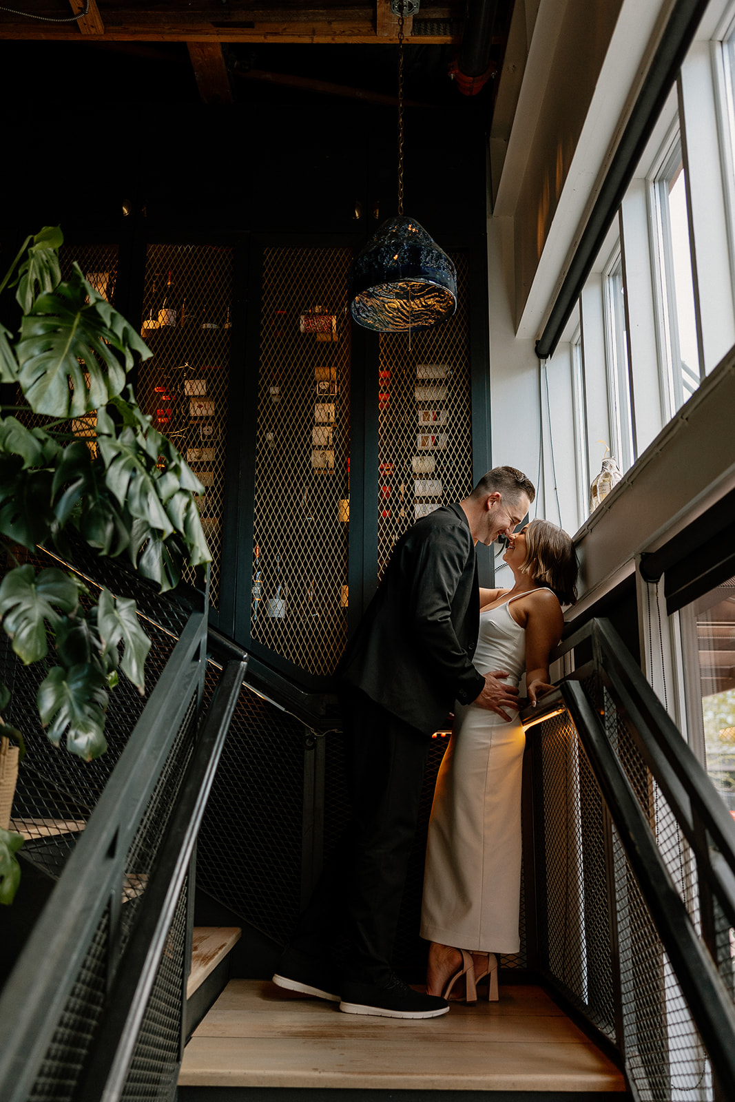 stunning couple share an intimate moment during their Arizona bar engagement photoshoot