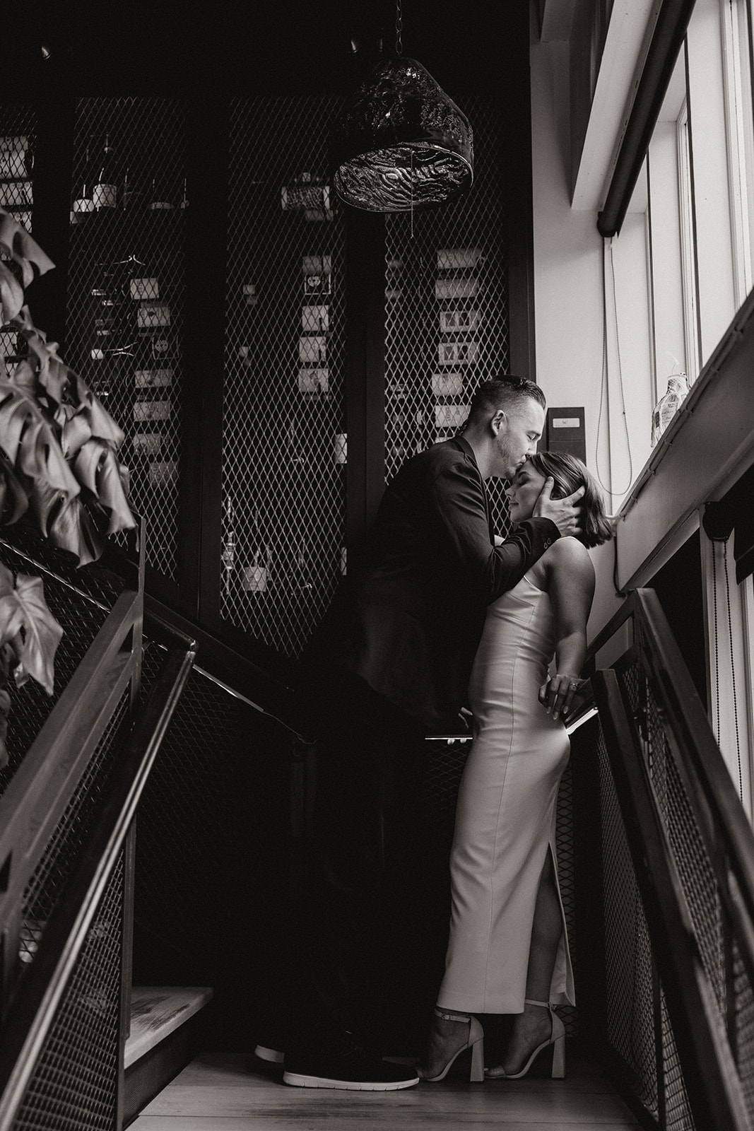 stunning couple share an intimate moment during their Arizona bar engagement photoshoot