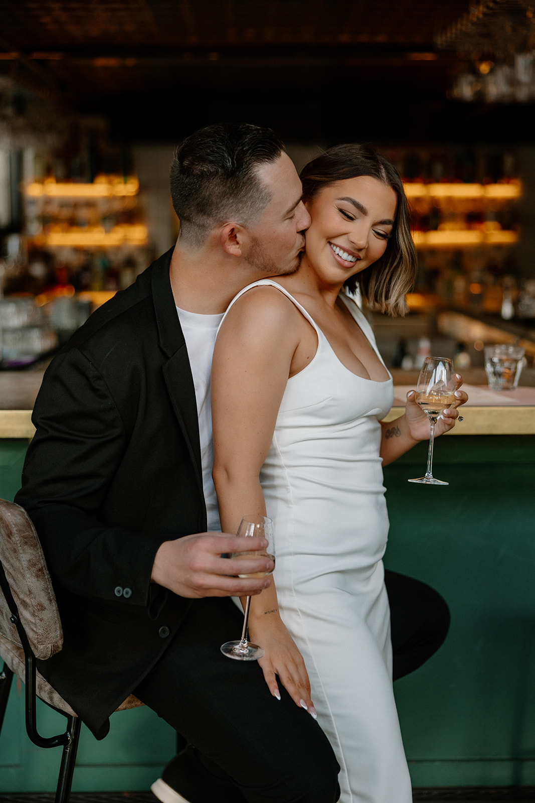 stunning couple share an intimate moment during their Arizona bar engagement photoshoot