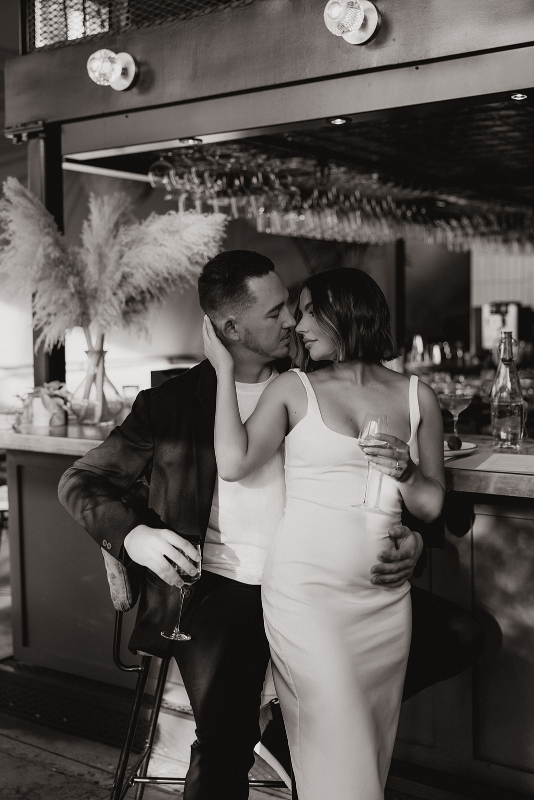 stunning couple share an intimate moment during their Arizona bar engagement photoshoot