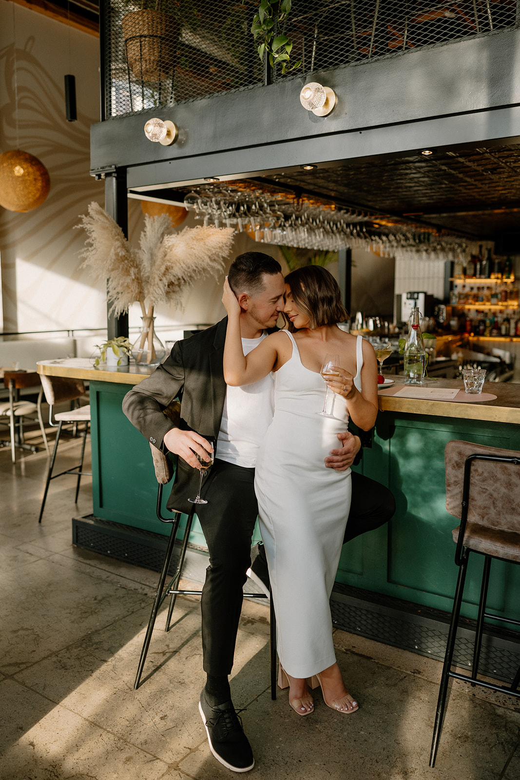 stunning couple share an intimate moment during their Arizona bar engagement photoshoot