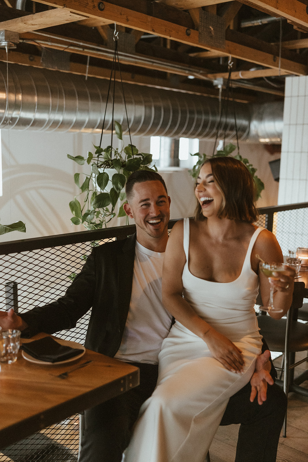 stunning couple share a candid laugh during their natural engagement photoshoot