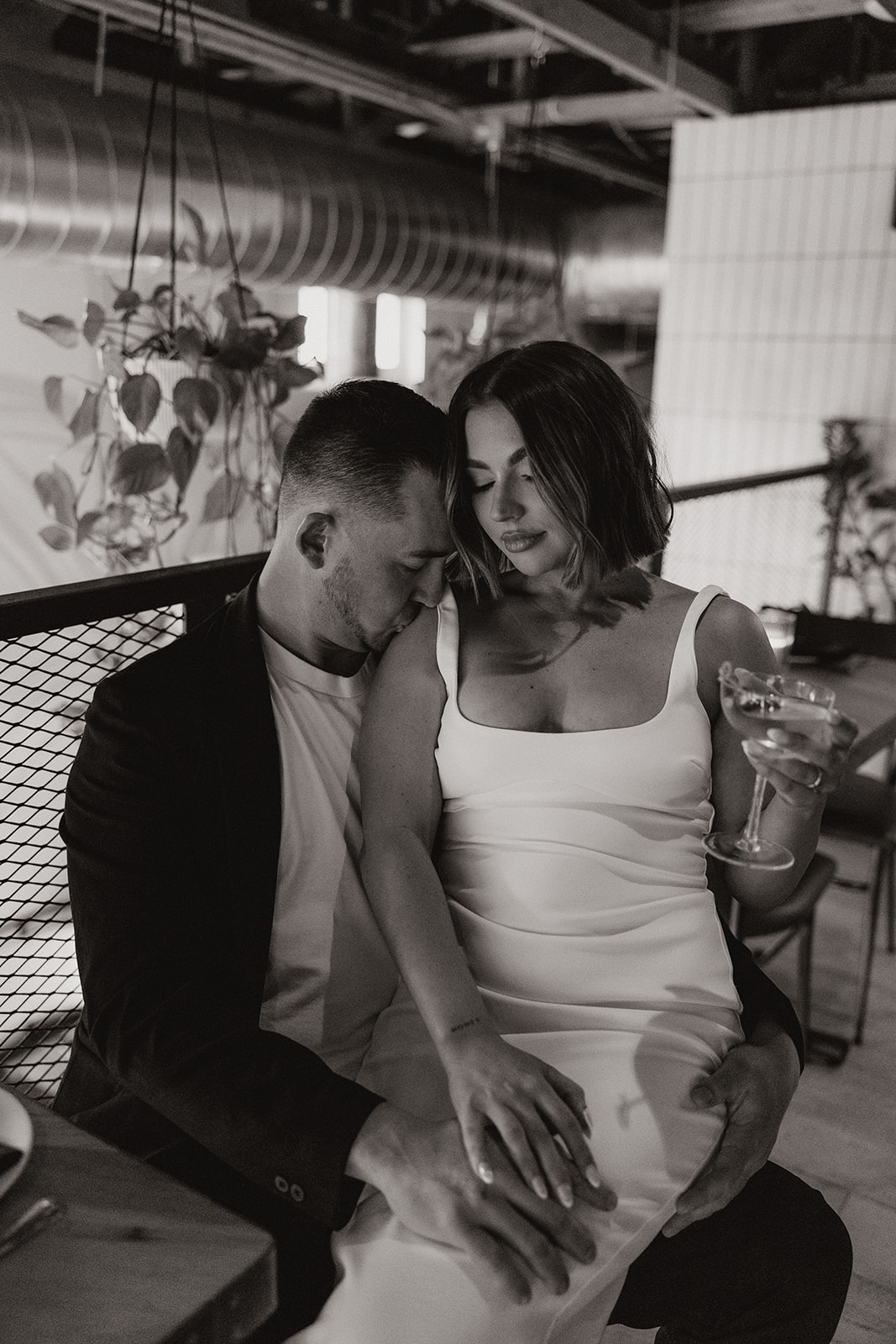 stunning couple share an intimate moment during their Arizona bar engagement photoshoot