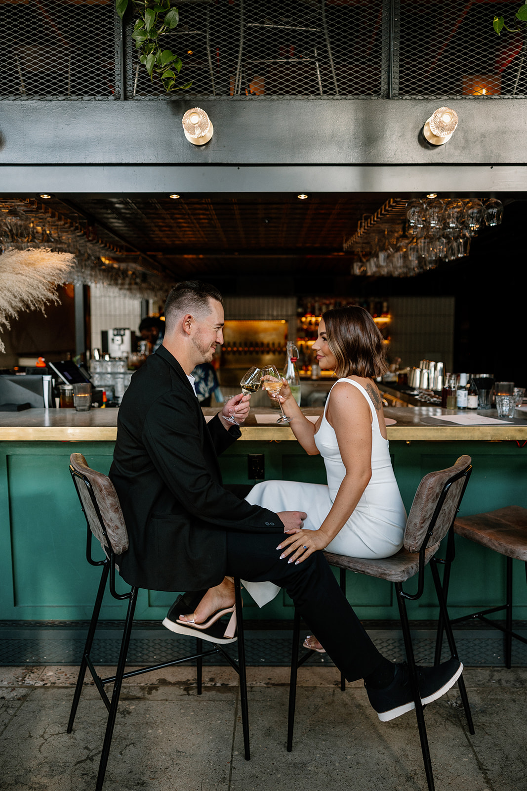 stunning couple share an intimate moment during their Arizona bar engagement photoshoot