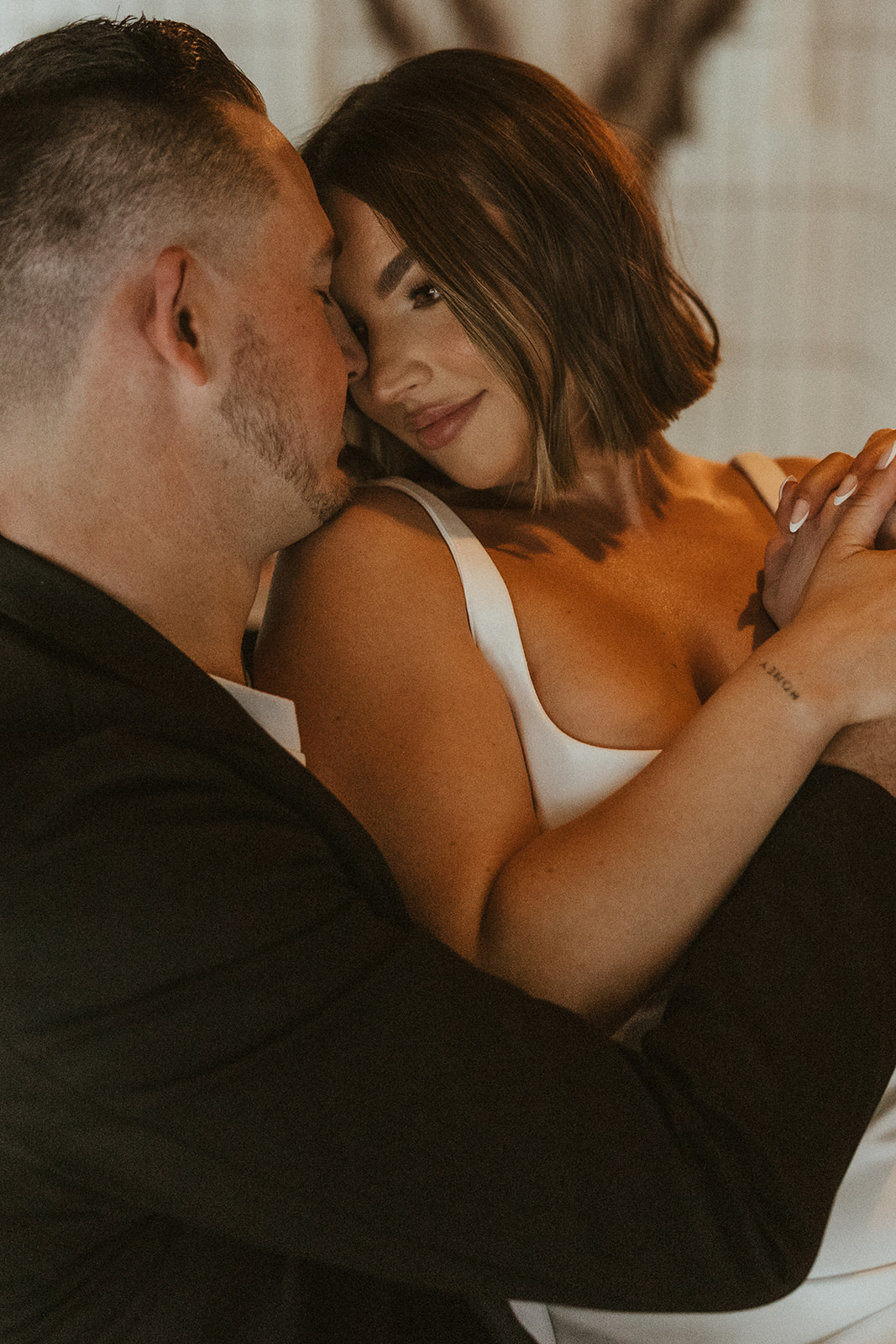 stunning couple share an intimate moment during their Arizona bar engagement photoshoot