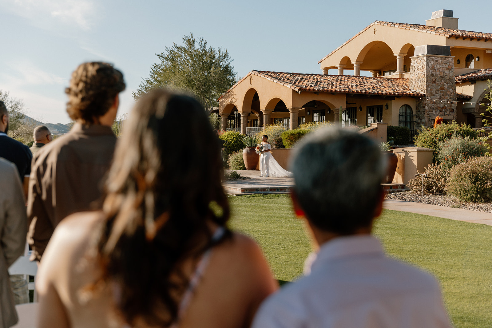 family looks on as the candid first look photoshoot happens