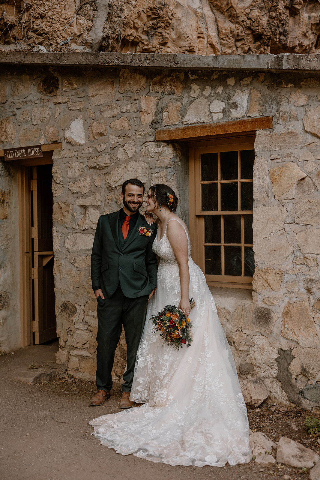 bride and groom pose together 