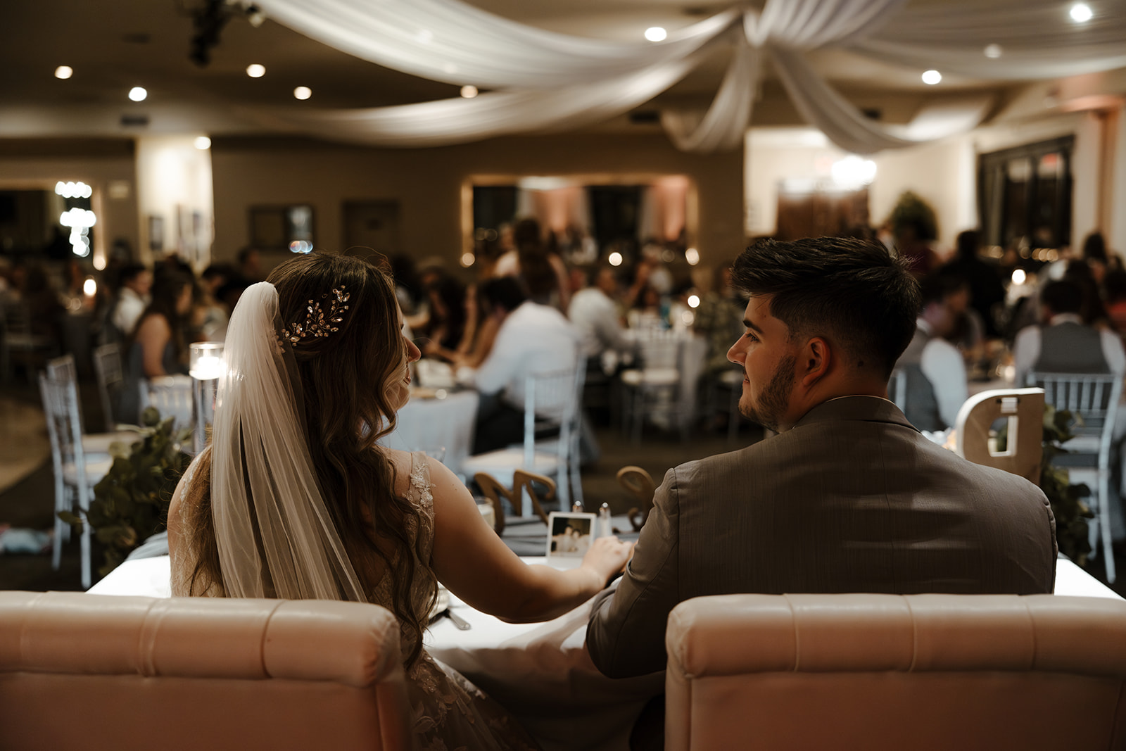 photo of bride and groom at their wedding reception. Include ample time in your wedding day timeline for your wedding reception photos