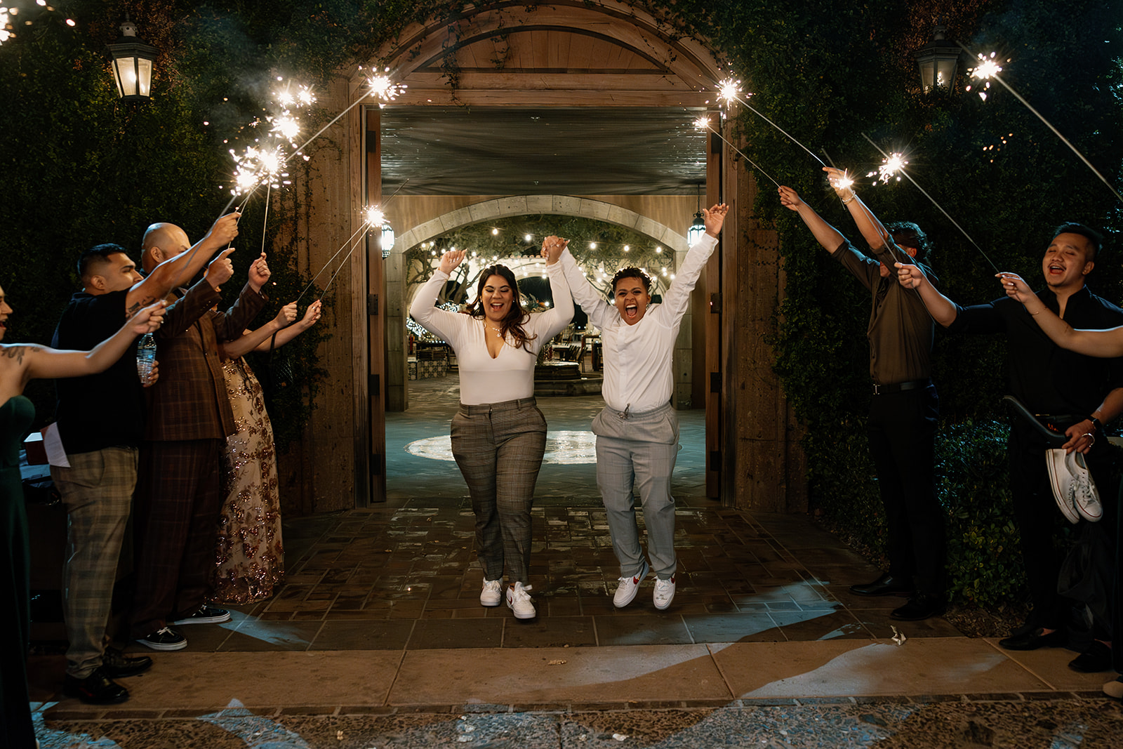 stunning brides enter their elegant wedding reception together during their dreamy blackstone country club wedding