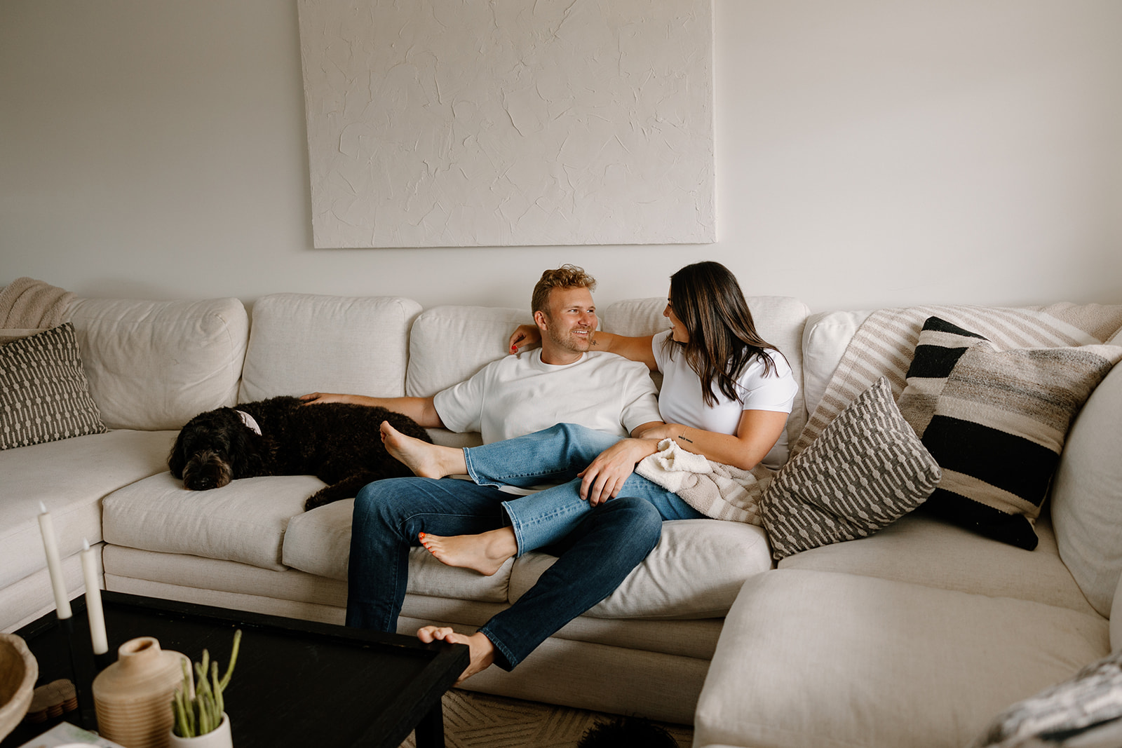 beautiful couple pose with their dogs during their in home engagement session