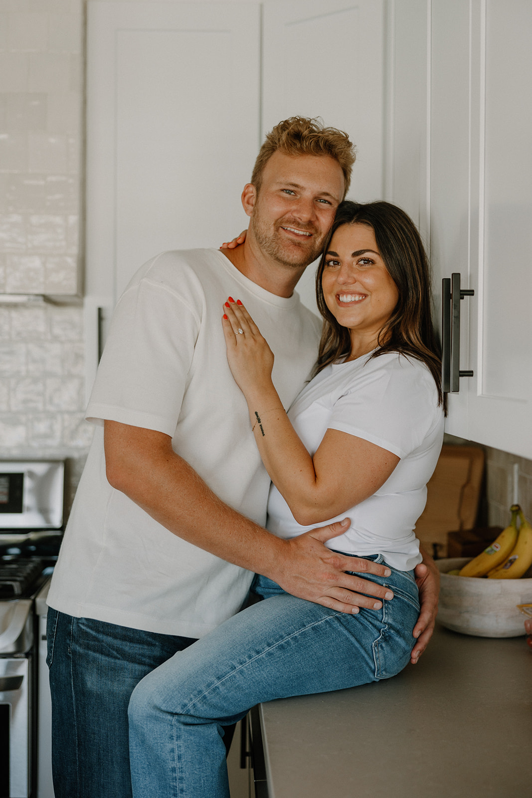 couple cooks together during their in home engagement photoshoot