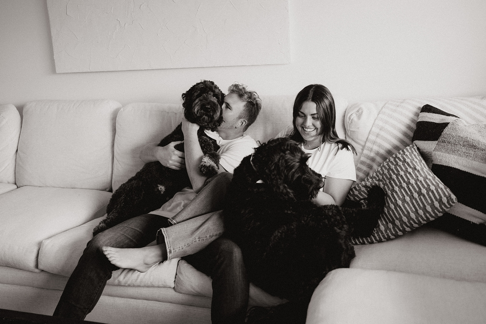 beautiful couple pose with their dogs during their in home engagement session