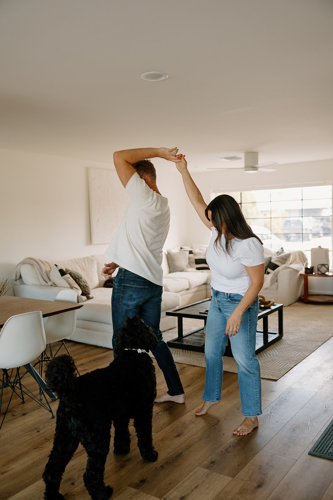 beautiful couple pose with their dogs during their in home engagement session